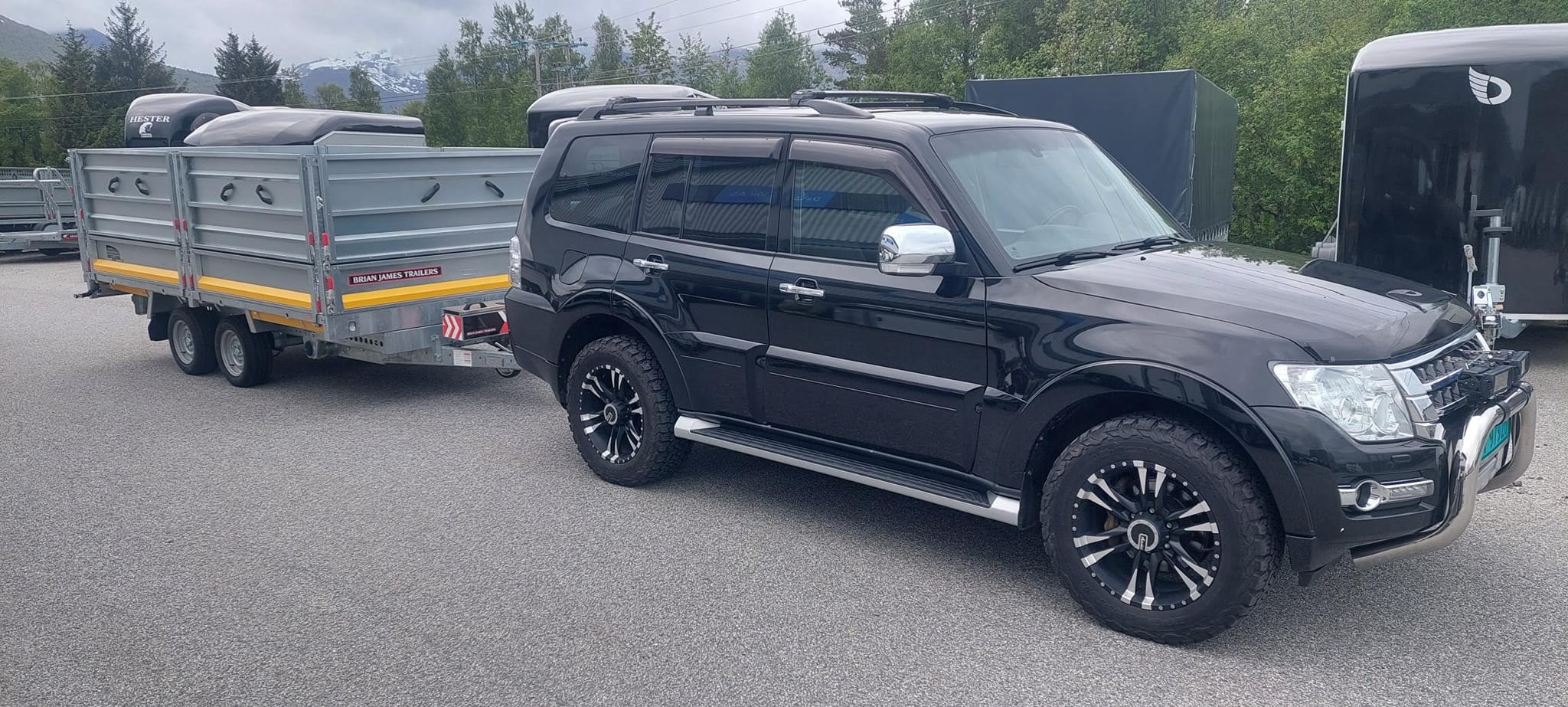 Image of a large SUV with a trailer attached